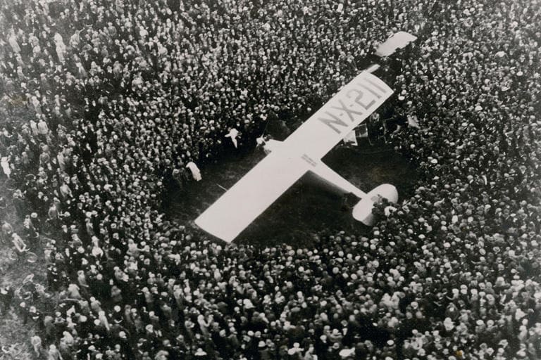 The monoplane 'Spirit of St. Louis' surrounded by a crowd.
