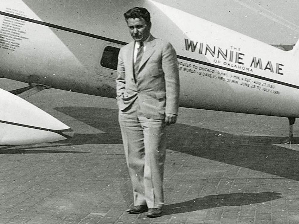 Wiley Post in front of his plane 'Winnie Mae'.