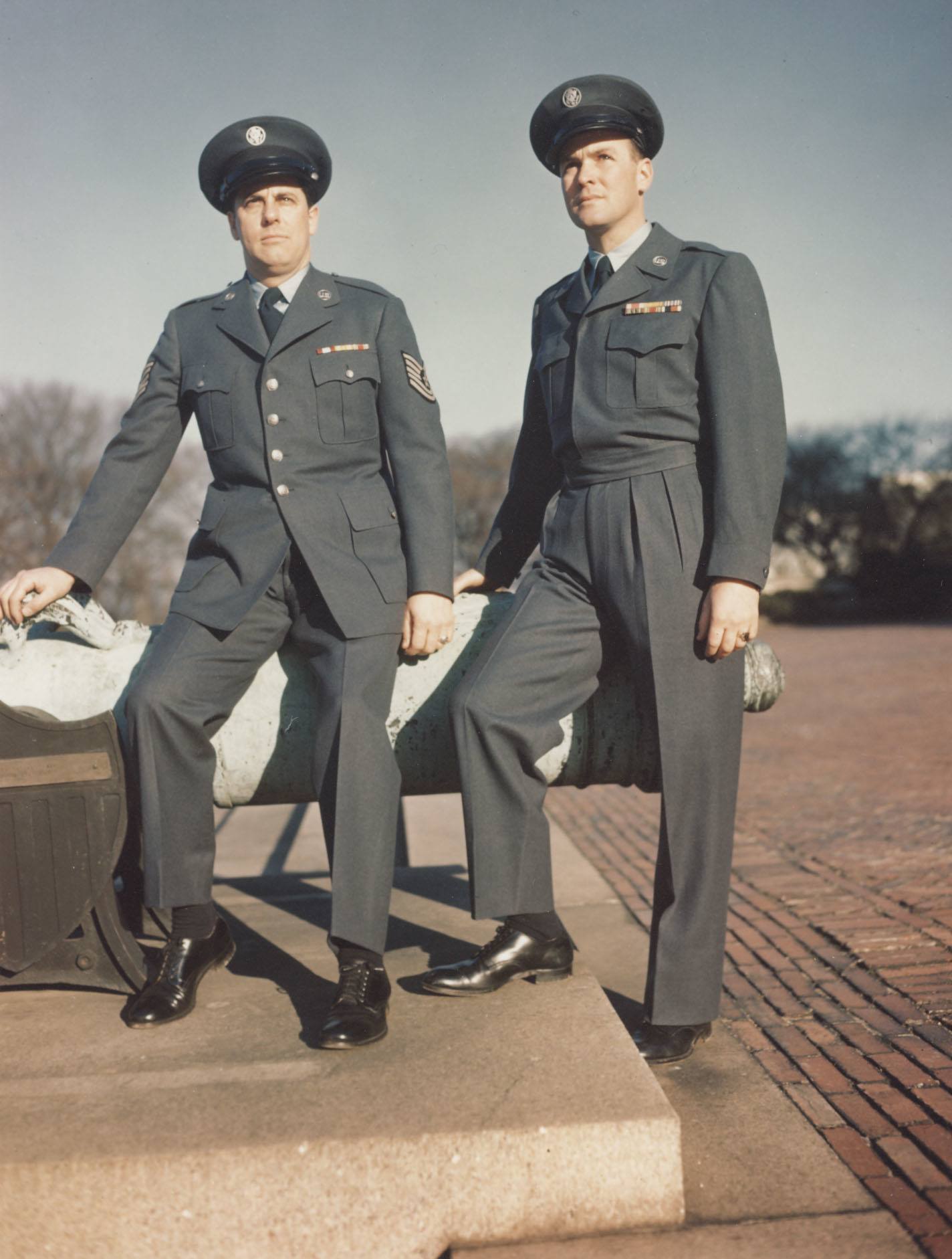 Two men wearing blue uniforms.
