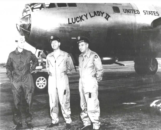 Three men in front of the B-50A 'Lucky Lady II' plane.
