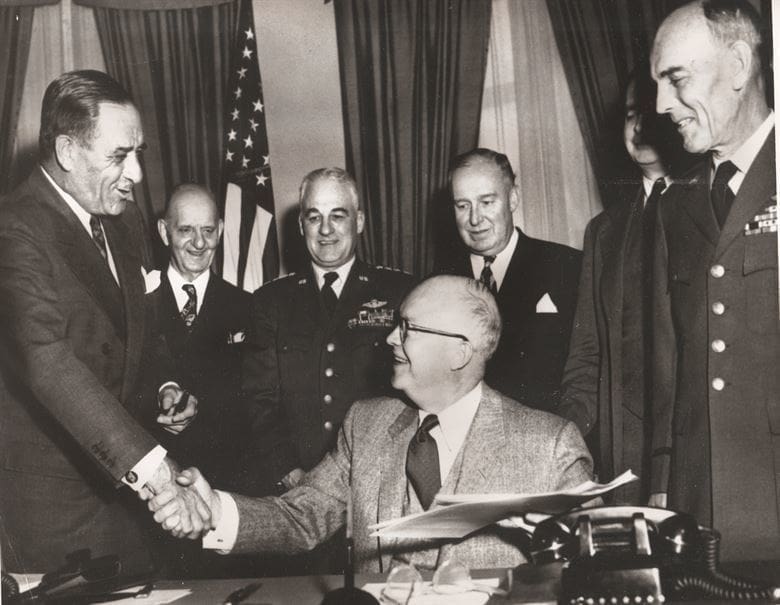 President Dwight D. Eisenhower signing a bill.