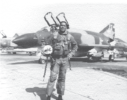 General Daniel 'Chappie' James Jr. standing in front of his McDonnel-Douglas F-4C Phantom Airplane.