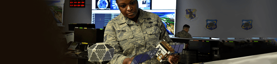 A woman wearing fatigues working.