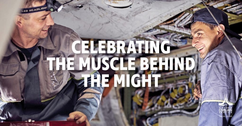 Two men in work attire, with the text "CELEBRATING THE MUSCLE BEHIND THE MIGHT" in the center.