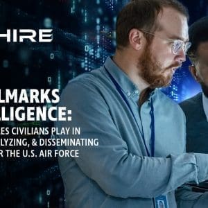 Aim Hire Episode 15: The Hallmarks of Intelligence: The Critical Roles Civilians Play in Collecting, Analyzing, & Disseminating Intelligence for the U.S. Air Force. Two men work on a laptop together.
