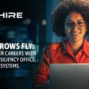 Aim Hire Episode 19: As the CROWS Fly, a woman wearing glasses smiling, a laptop in front of her.