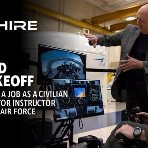 Aim Hire Episode 27: Cleared for Takeoff, A man using a simulator with another man explaining it.